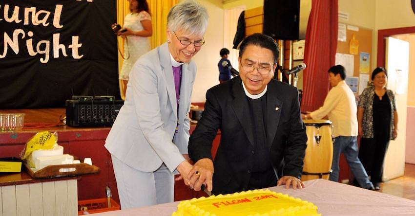 Bishop Melissa cutting the cake