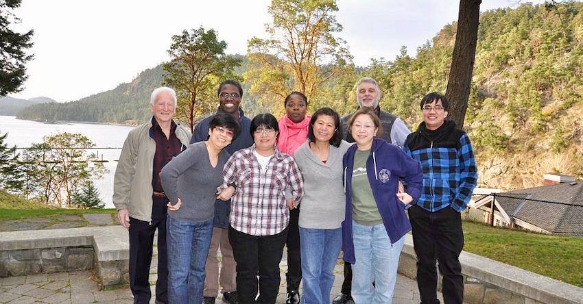 Group photo in front of lake